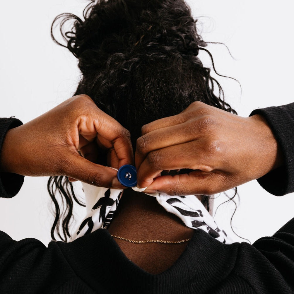 woman attaching loop and button