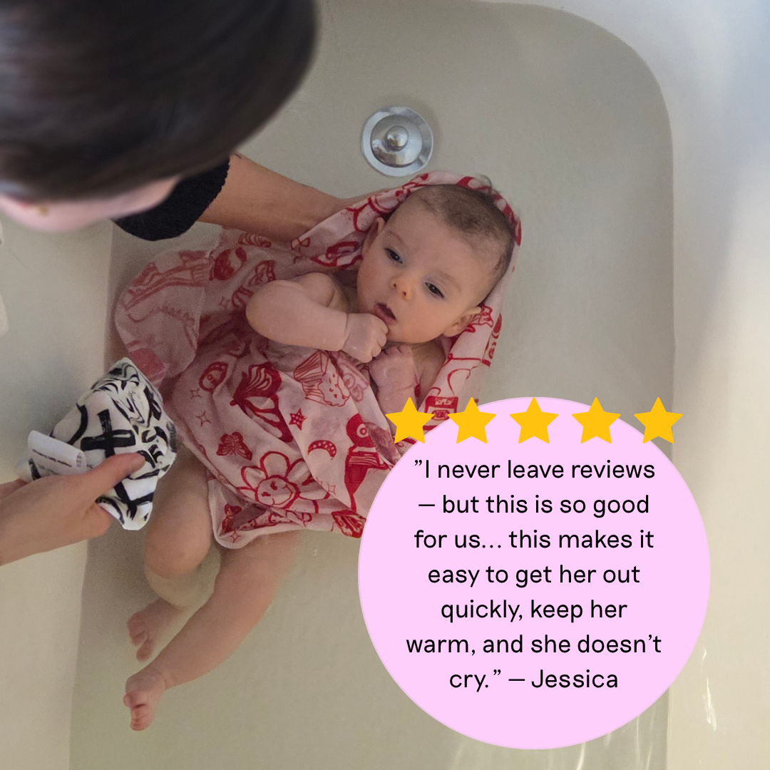 A baby wrapped in a pink and red floral bath towel sits in a white bathtub while an adult supports them. A pink review bubble with yellow stars and a testimonial quote is overlaid on the right side.