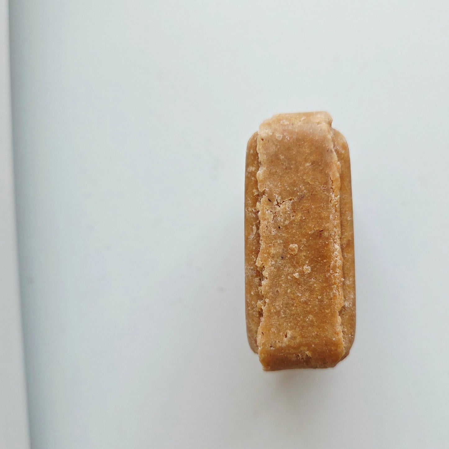 A single Bare. Wash Bar standing on its side on a plain white surface.