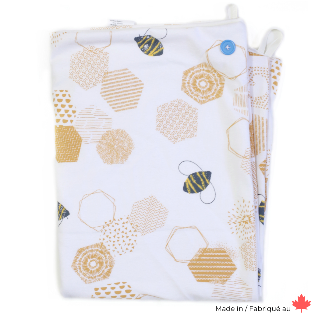 Wearable Hands Free towel with a blue button in a Gold geometric honeycomb pattern with some black bees on a white background.