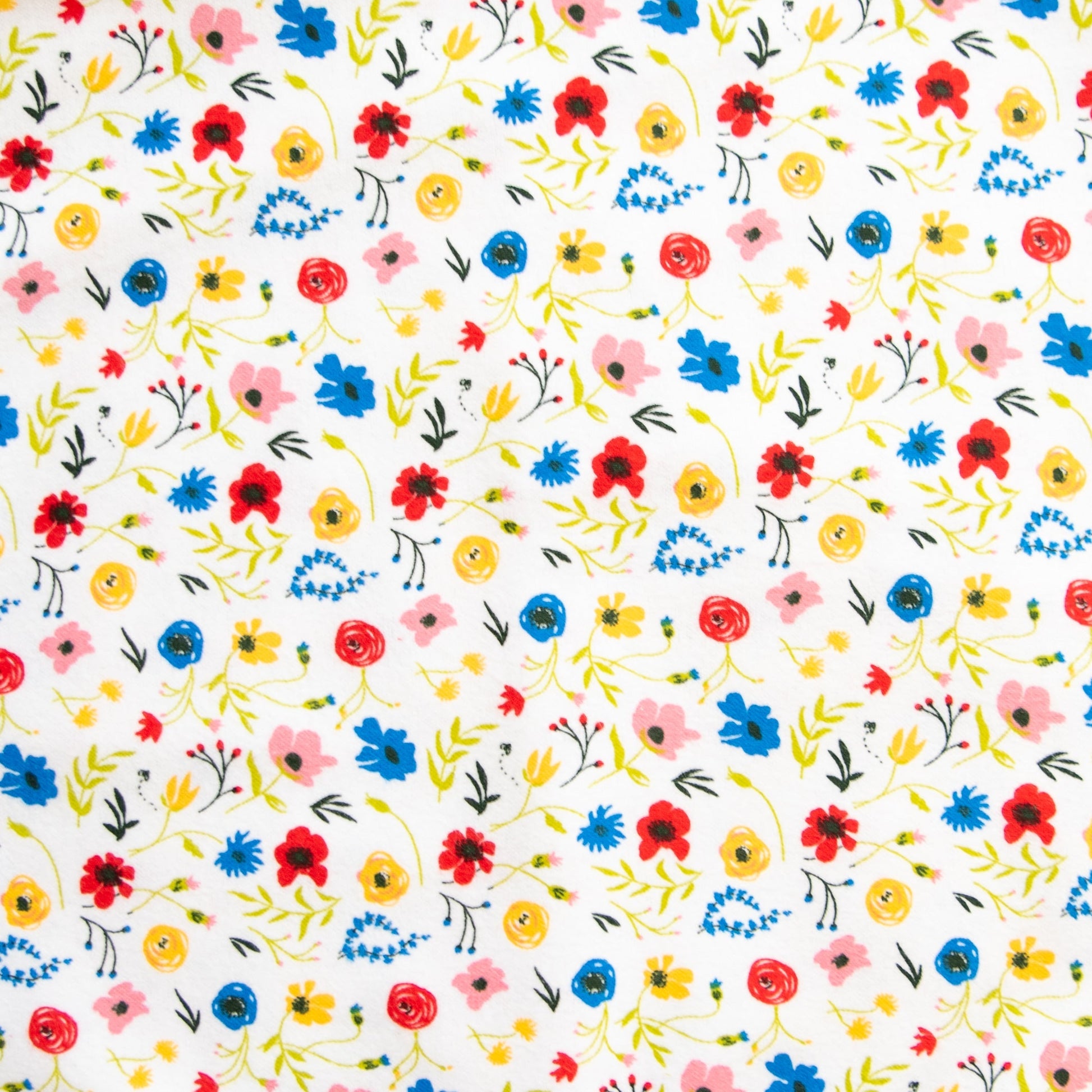 Oneberrie Hair Wrap Towel fabric close-up in wildflower print with red, blue, yellow and pink flowers on white