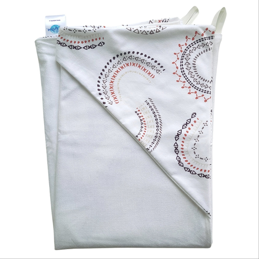 A folded baby towel featuring a printed geometric pattern in brown, taupe, black and muted red hood on a white terry towel. 