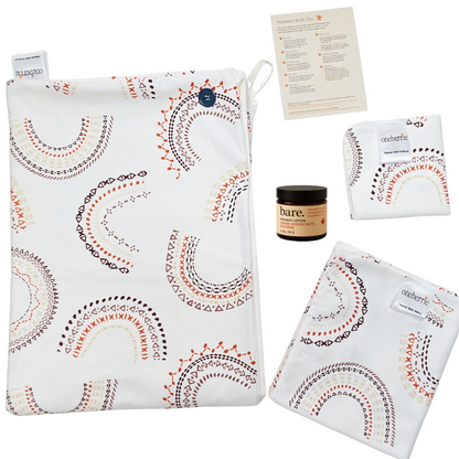 Bath bundle consisting of Hands Free towel, Washcloth, Bath swaddle and Bare. Lotion with a how to bathe a newborn card. 