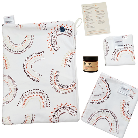 Bath bundle consisting of Hands Free towel, Washcloth, Bath swaddle and Bare. Lotion with a how to bathe a newborn card. 