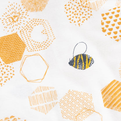 Gold honeycomb geometric print with a black and yellow bee on a white background