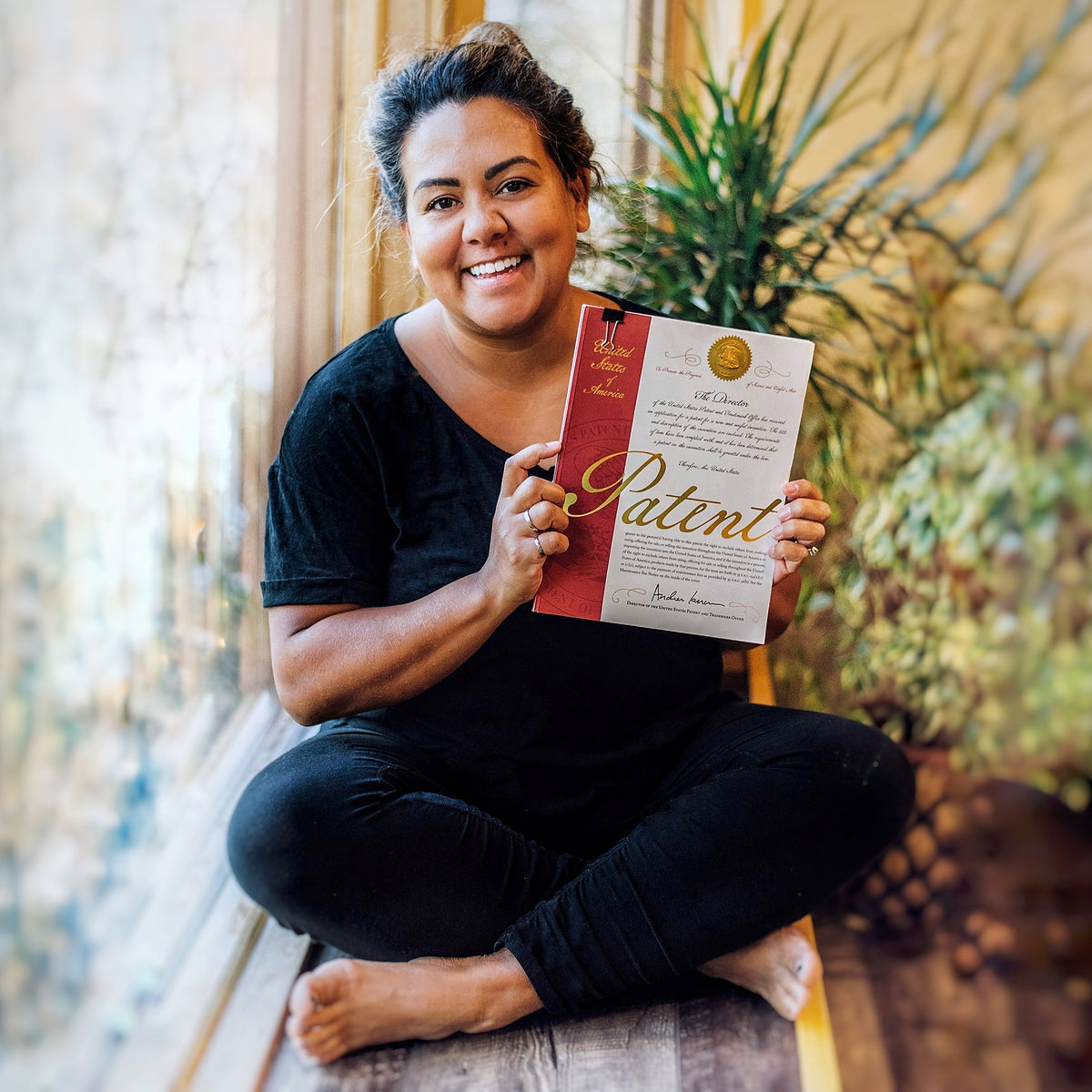 Sue-Rose, Oneberrie founder, holding her patent certificate