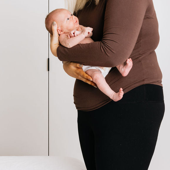 Women postpartum holding a newborn baby