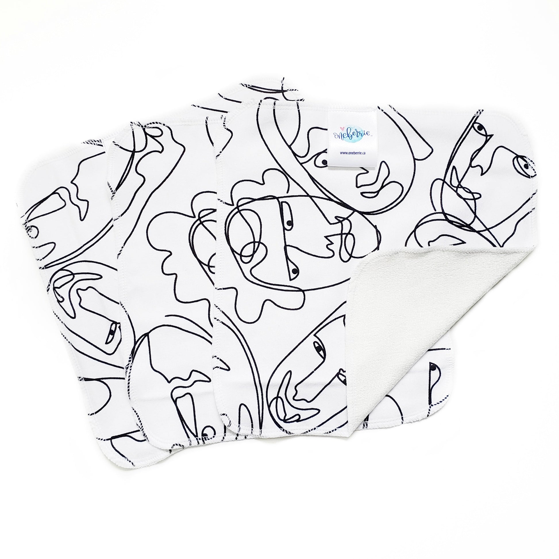 Graffiti print - line faces in black on a white background 
