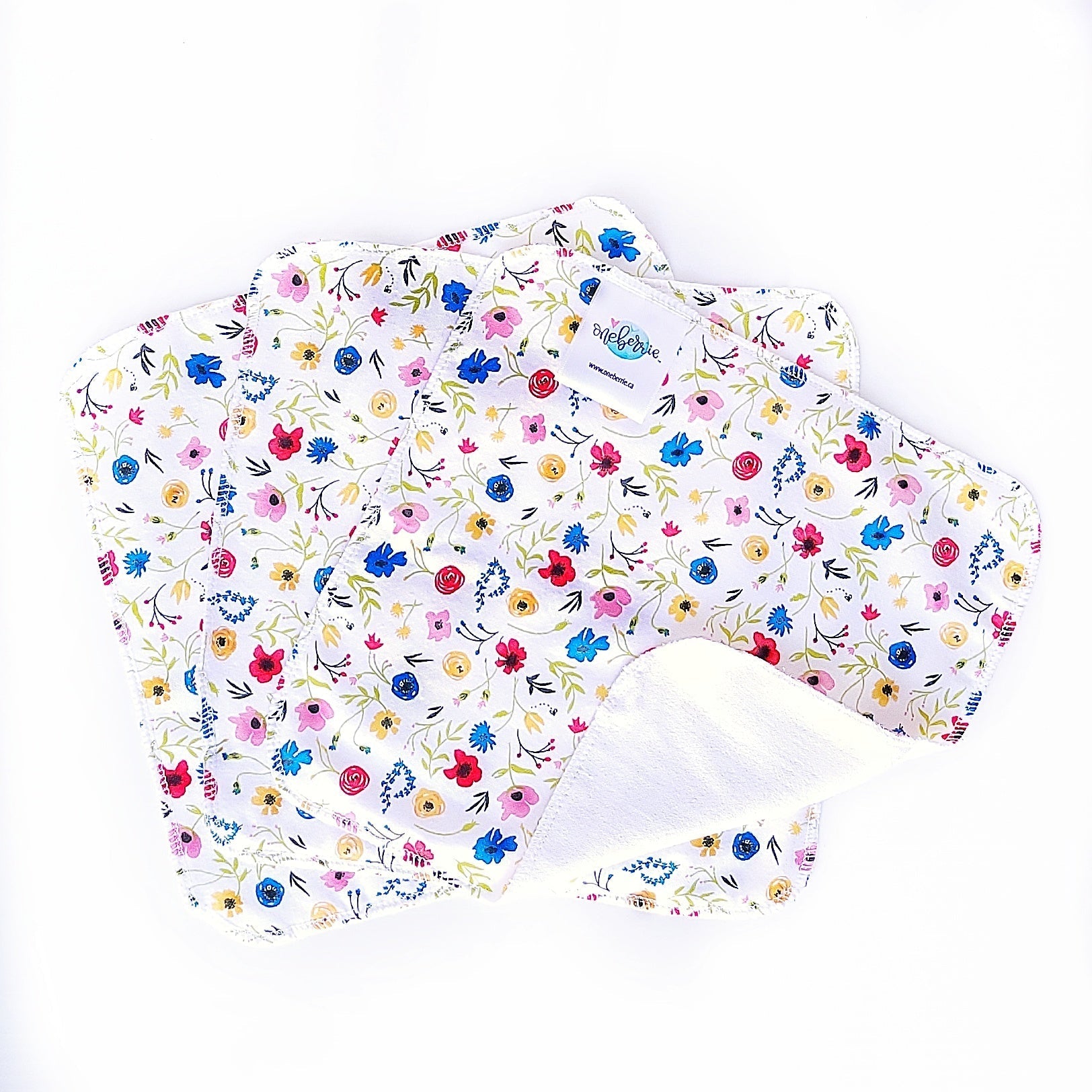 wildflower print of red, blue, yellow and pink  wildflowers on a white background 