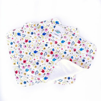 wildflower print of red, blue, yellow and pink  wildflowers on a white background 