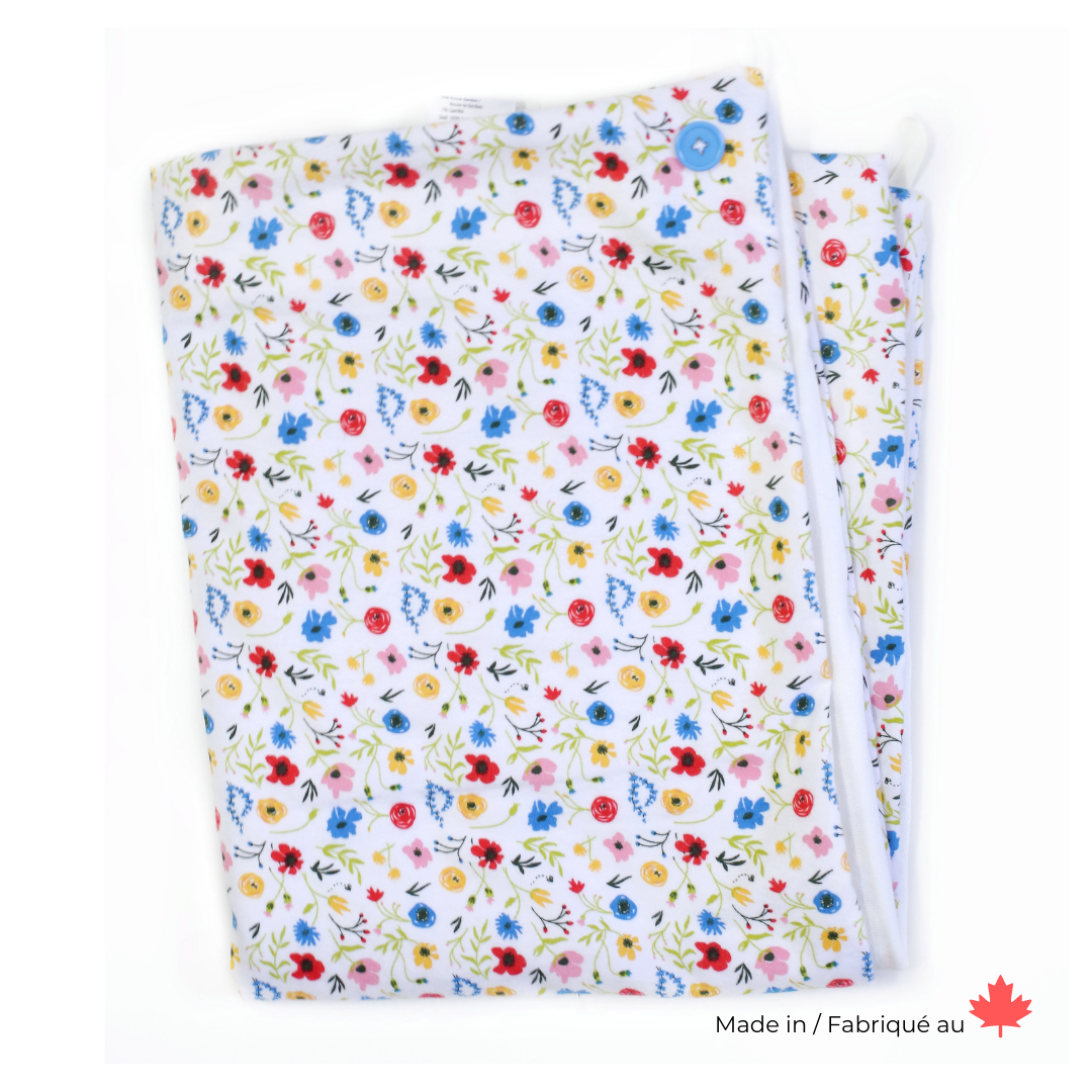 A soft baby towel with a wildflower pattern in pink, blue, red and yellow flowers
