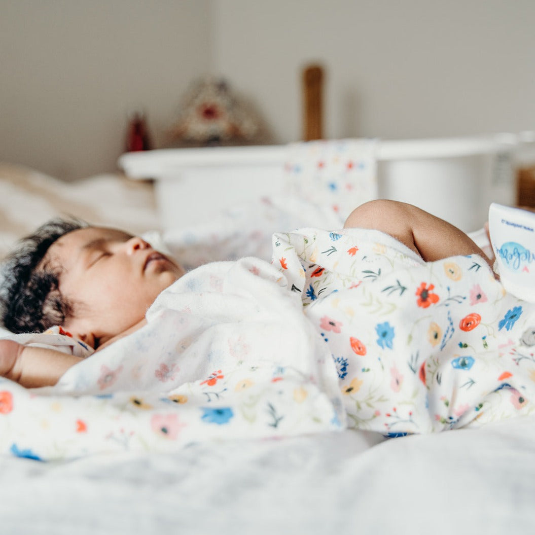 Newborn sleeping on a swaddle
