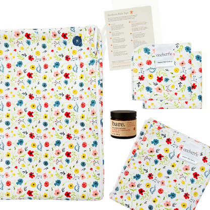 Floral-patterned products including a hands free towel, matching washcloth, wipe and bath swaddle, and a 2oz Bare. Lotion
