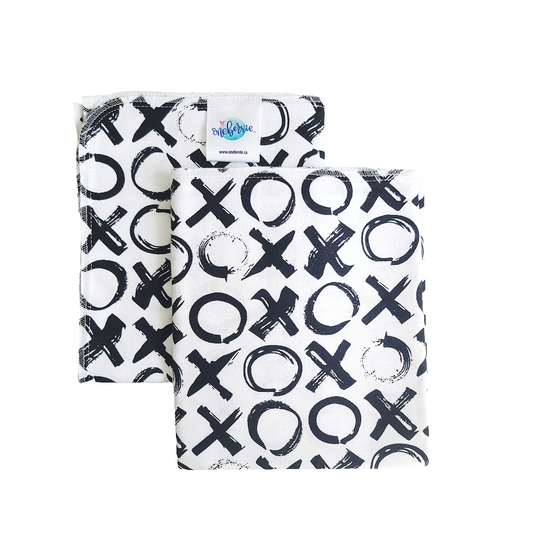 Two folded baby bath swaddles with a black and white xoxo pattern on a white background.