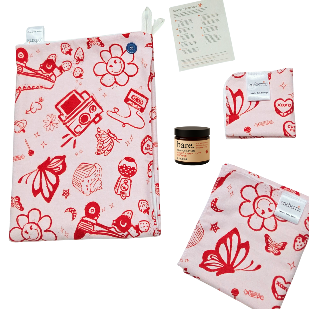 Retro red and white patterned set on a white background. Set includes towel, washcloth, swaddle, 2oz lotion and card. Retro print includes polaroid camera, butterfly, gumball machine and cupcake. 