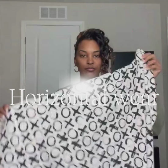 Mom bathing her baby using the horizontal wear in the Love you more print